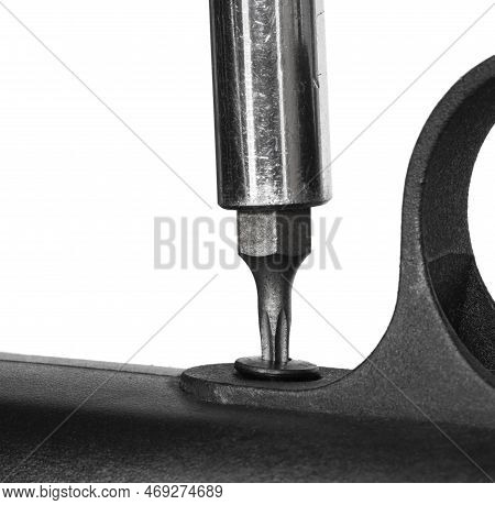 Trigger Guard Being Removed On A Rifle By A Star Headed Screwdriver