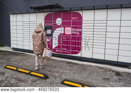 Loriol Sur Drome, France - January 14, 2023: Picking Up A Parcel From A Mondial `relay Locker By A Y