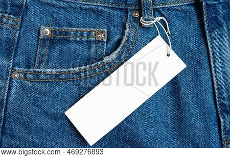 Front Side Pocket And Price Tag Of Blue Jeans Pants Close-up. Denim Background, Texture, Mockup. Fas
