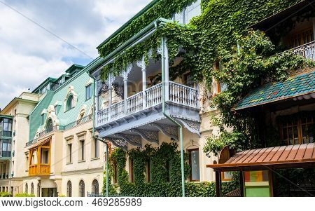 Carved Wooden Balcony And Colorful Buildings In Historical Tbilisi, Georgia. Traditional Decoration 
