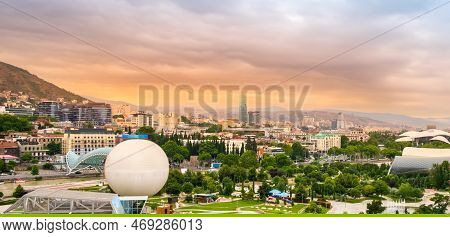 Tbilisi, Georgia With Rike Park On Bank Of Mtkvari Or Kura River, Bridge Of Peace, Hot Air Balloon A