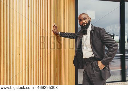 A Gallant Black Man With Drool And A Bald Head, Wearing A Tuxedo, Black Bow Tie, And White Shirt; Ha