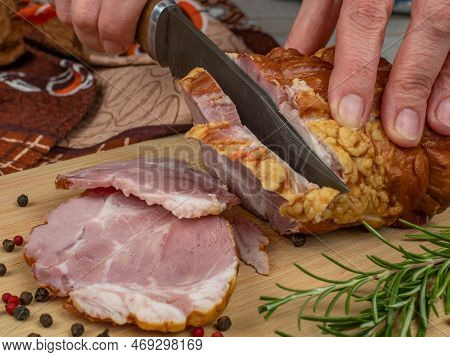 A Piece Of Juicy And Tasty Bacon Is Cut With A Kitchen Knife Into Appetizing Pieces. Close-up Of Fem