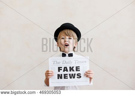 Newsboy Shouting Against Grunge Wall Background. Boy Selling Fake News