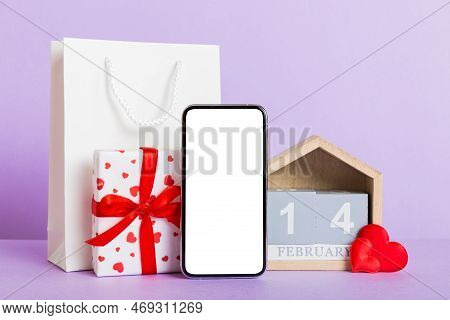 Mobile Phone With Blank Screen On Colored Background With Hearts, Calendar And Gift Box, Valentine D