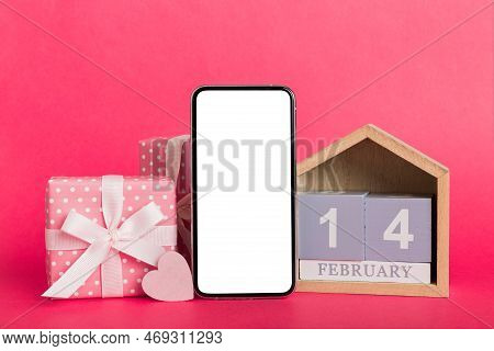 Mobile Phone With Blank Screen On Colored Background With Hearts, Calendar And Gift Box, Valentine D
