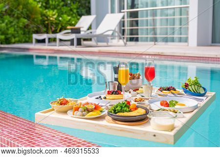 Breakfast In Swimming Pool, Floating Breakfast In Luxurious Tropical Resort. Table Relaxing On Calm 