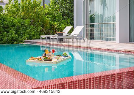 Breakfast In Swimming Pool, Floating Breakfast In Luxurious Tropical Resort. Table Relaxing On Calm 