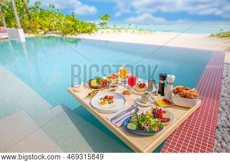 Breakfast In Swimming Pool, Floating Breakfast In Luxurious Tropical Resort. Table Relaxing On Calm 