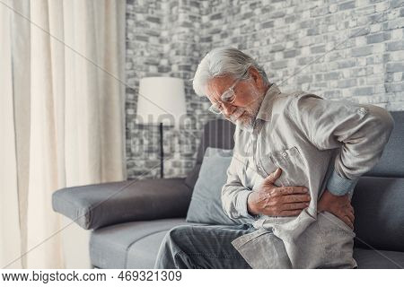Upset Senior Elder Man Feel Sudden Back Pain Muscles Ache Tension Injury Sitting At Home, Sad Old Gr