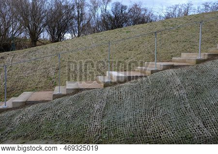 Outdoor Park Stairs On A Slope. Jute Mat Protects Against Erosion. Seed Spraying In A Cellulose Hydr