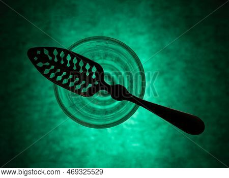 Traditional Slotted Absinthe Spoon On The Top Of Absinthe Glass, Flat Lay, Selective Focus