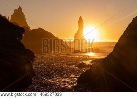 Black Sand Beach In Iceland. Sunset Over Volcanic Cliffside. Stunning Ocean Coast. Unusual Mountain 