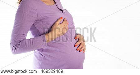 A Pregnant Girl In A Purple Blouse Holds Her Chest. The Concept Of Pain And Changes In The Female Br