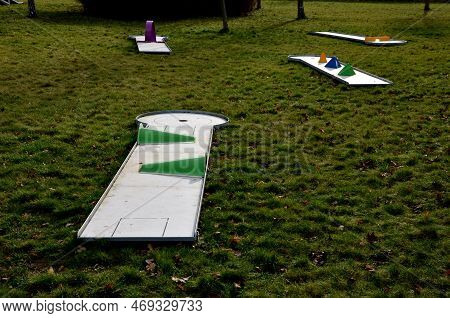 Minigolf Course In Park Catch Golf Balls Behind Obstacle. Game For Points Below Par Or Above Par, Re