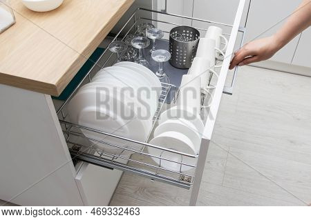 Pull-out Shelf With Dishes In A Modular Kitchen. Modern Kitchen Furniture. Production Of Kitchens Un