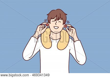 Happy Man Uses Earplugs And Neck Pillow To Rest During Long Journey On Bus Or Plane. Positive Guy Tr