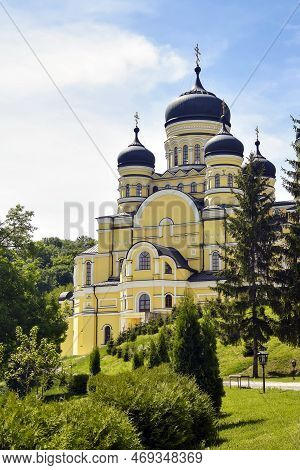 View Of Orthodox Cathedral With Domes In Monastery Against Background Of Green Landscape And Cloudy 
