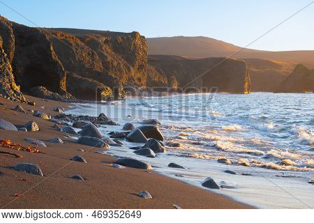 Scenic Beach With Black Sand By Low Tide At Sunset Near Kopasker Village, Volcanic Coastline In Icel
