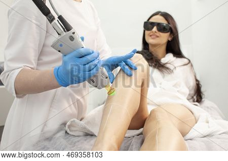 Leg Hair Removal With Alexandrite Laser. Woman Client In Cosmetology Clinic Doing Leg Epilation With