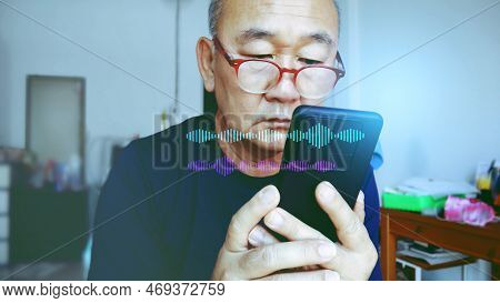 Senior Asian Man Using Microphone Application On Mobile To Communicate On Dairly