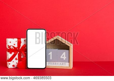 Mobile Phone With Blank Screen On Colored Background With Hearts, Calendar And Gift Box, Valentine D