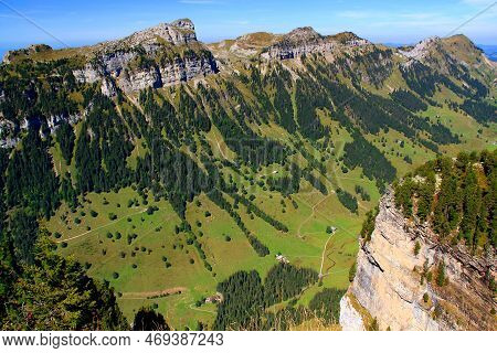 Landscape With The View Of The Mountain Range, A Hollow And Houses In It Against A Blue Sky With Clo