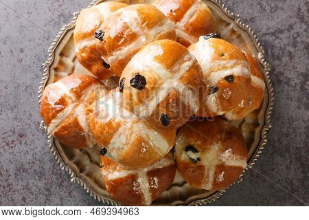 Freshly Baked Easter Cross Buns With Sultanas Closeup On The Plate On The Table. Horizontal Top View