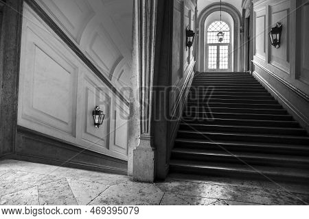 Mafra, Lisbon, Portugal- January 17, 2023: Corridor, Arches, Marble Staircase And Lamps Of The Palac