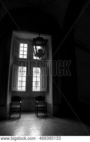 Mafra, Lisbon, Portugal- January 17, 2023: Chairs Next To Big Wooden Window Of The Palace- Convent O