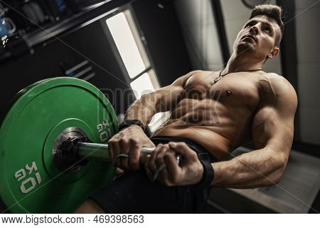 The Concept Of Cross-fit Training. A Close-up Shot From Below Of A Sexy Man With A Naked Upper Body 