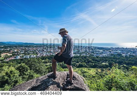 Asian Fat Man Stand On The Rock  Look At The Phone At Khao Hin Lek Fai View Point.khao Hin Lek Fai I