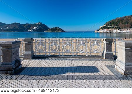 Walking On Promenade Along White Sandy La Concha Beach In Central Part Of Donostia Or San Sebastian