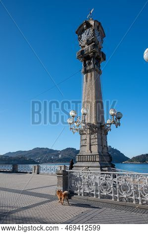 Walking On Promenade Along White Sandy La Concha Beach In Central Part Of Donostia Or San Sebastian