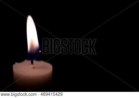 One Burning Candle In Dark Black Room