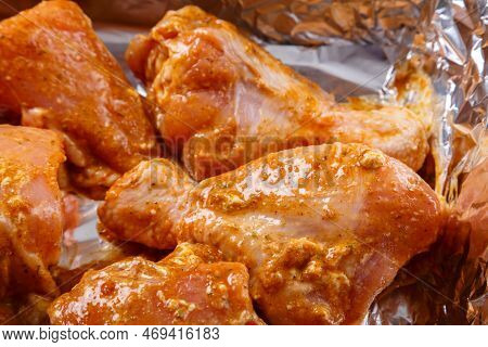 Chicken Parts In Soy Sauce And Spicy Spices Marinated On Foil. Horizontal Photo