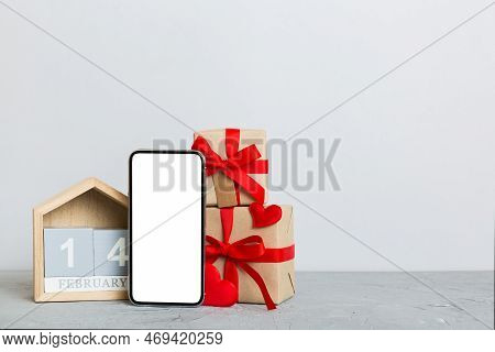 Mobile Phone With Blank Screen On Colored Background With Hearts, Calendar And Gift Box, Valentine D