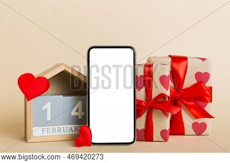 Mobile Phone With Blank Screen On Colored Background With Hearts, Calendar And Gift Box, Valentine D
