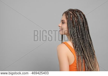 Beautiful Woman With Long African Braids On Grey Background, Space For Text