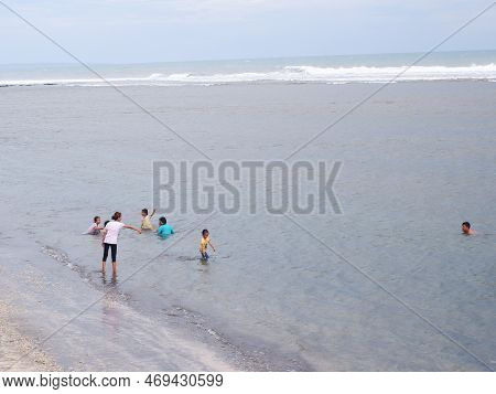 Garut, Indonesia- December 12,2022 : People Who Are Playing And Swimming On A Beautiful Tropical Bea