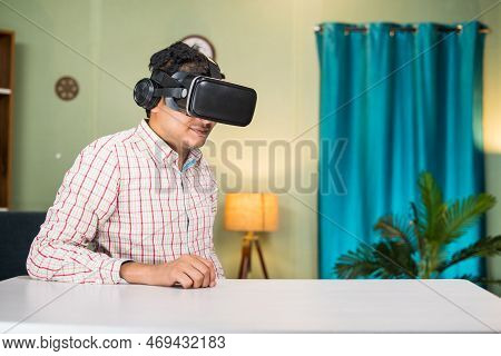 Thougtful Young Man With Virtual Reality Headset Looking Empty Table At Home - Concept Of Modern Tec