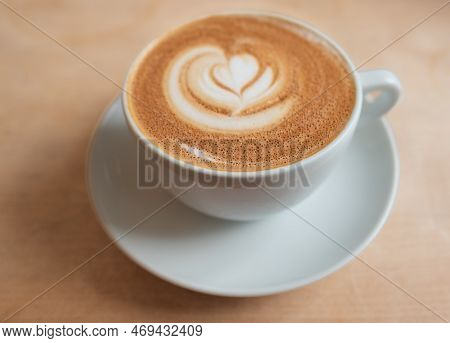 Good Morning Coffee. Cappuccino With Latte Art On Wooden Table. Beautiful Coffee Mug On A Rustic Tab
