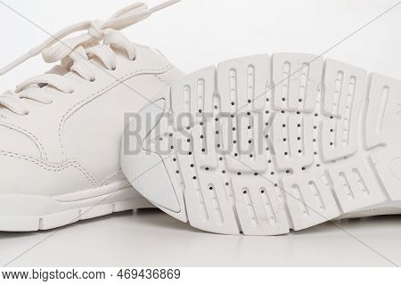 Leather Sneakers With Lacing And Perforated Sole On A White Background.