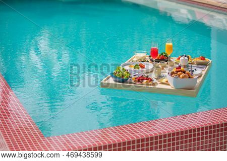 Breakfast In Swimming Pool, Floating Breakfast In Luxurious Tropical Resort. Table Relaxing On Calm 
