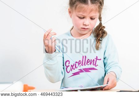 Little Girl Learning How To Sew With Sewing Craft Kit For Kids.