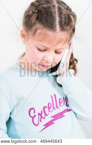 Little Girl Talking On The Phone With Her School Friends.