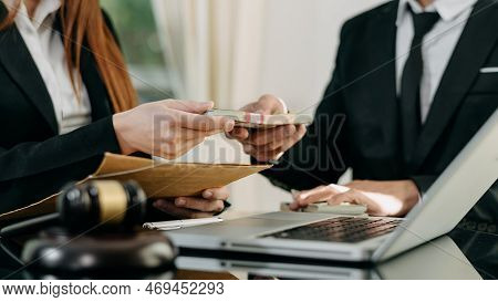 Justice And Law Concept.passing Bribe Money In The Envelop At  Office.