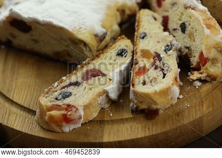 Traditional Stollen With Decoration On Wooden Background