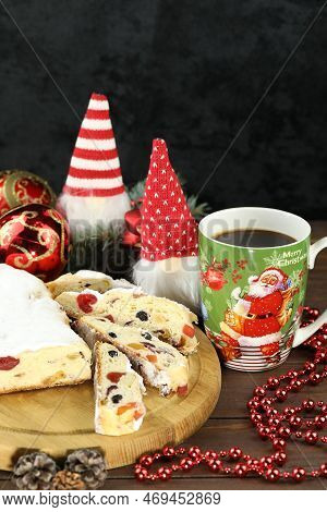 Traditional Stollen With Decoration And Cup Of Coffee On Wooden Background