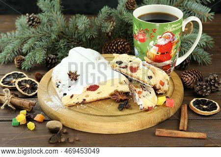 Traditional Stollen With Decoration And Cup Of Coffee On Wooden Background